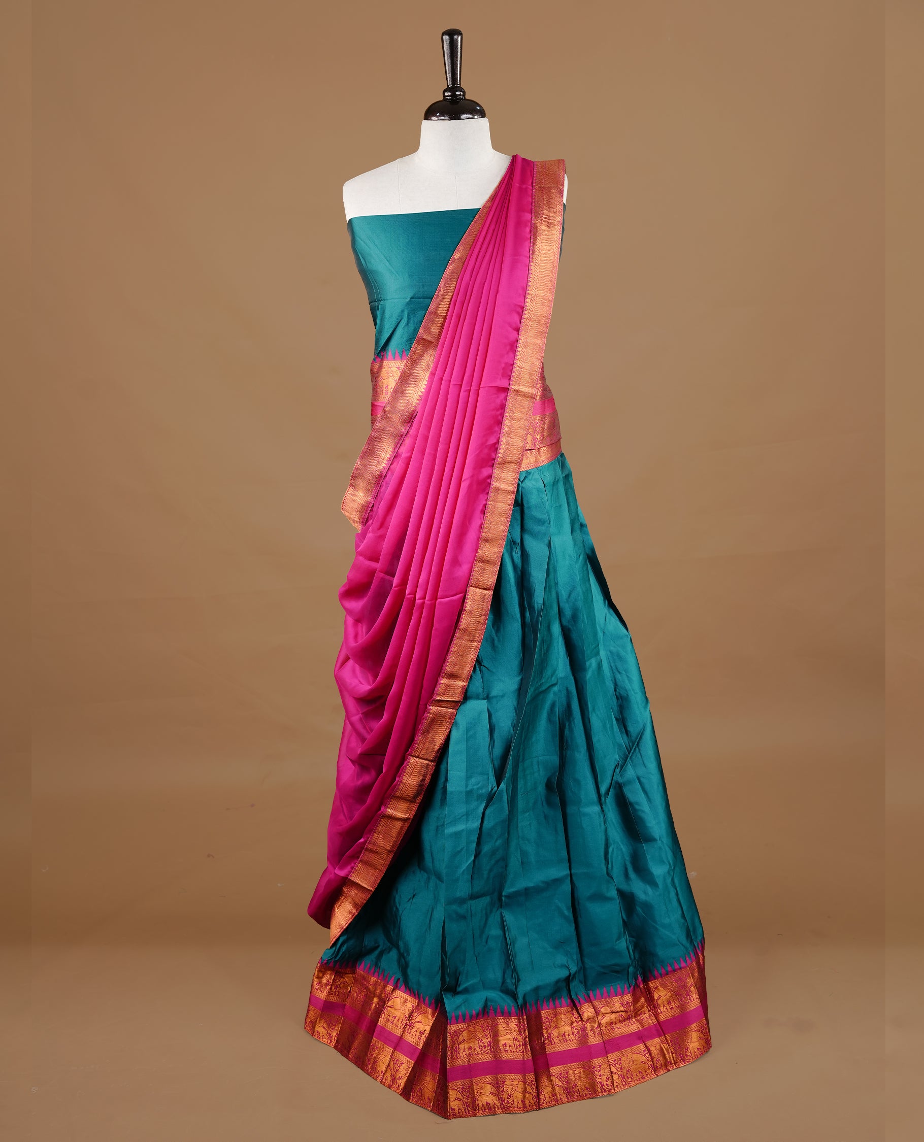 Green colour semi stitched Half saree featuring contrast Magenta colour with gold zari traditional border skirt, paired with matching zari border dupatta, unstitched blouse piece