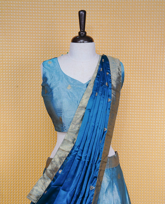 Greyish Blue colour Dhavani set featuring a Greyish blue colour skirt with Self colour border with rich gold zari pattern, paired with a Matching dupatta detailed with Gold motifs