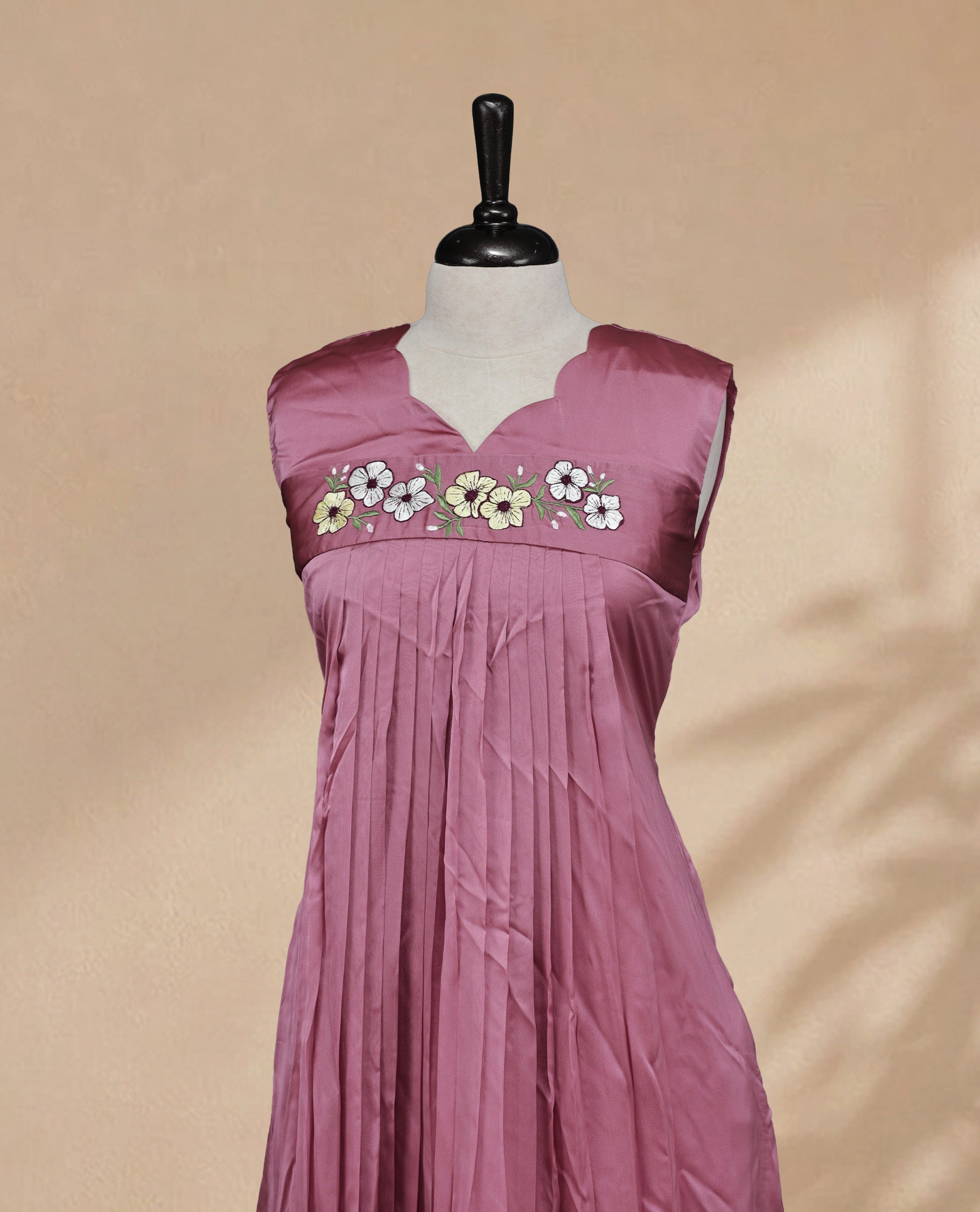 Salmon Pink Coloured Sleeveless Kurti Featuring a Designed Neckline, Floral Embroidery on the Body