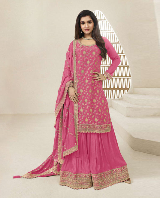 Pink colour semi stitched salwar suit featuring an embroidered chinon top material paired with a matching sharara  bottom, and dupatta.
