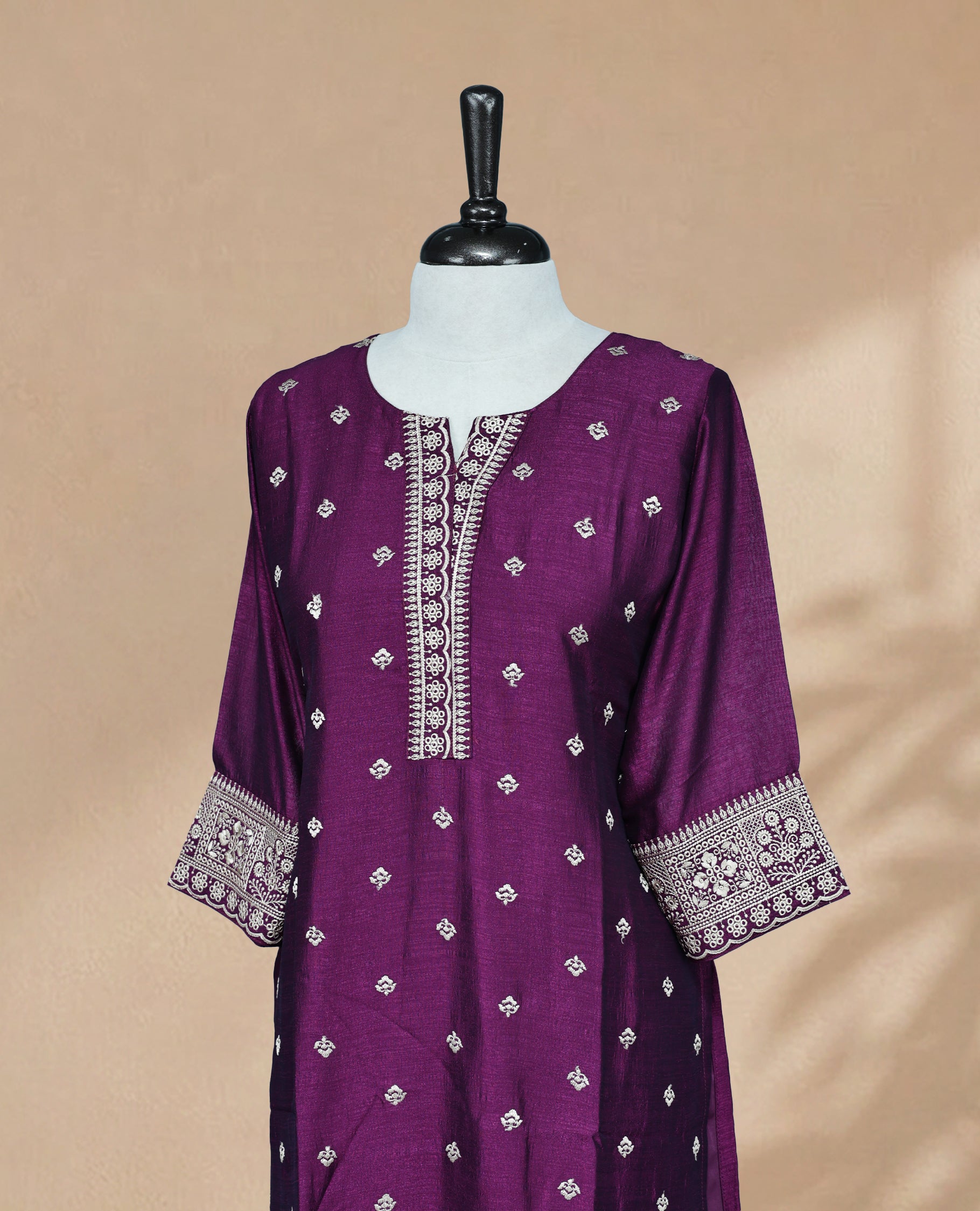 Dark Plum  Kurti featuring threadwork across the body, a U-shaped neckline adorned with threadwork, and 3/4 sleeves with matching threadwork.