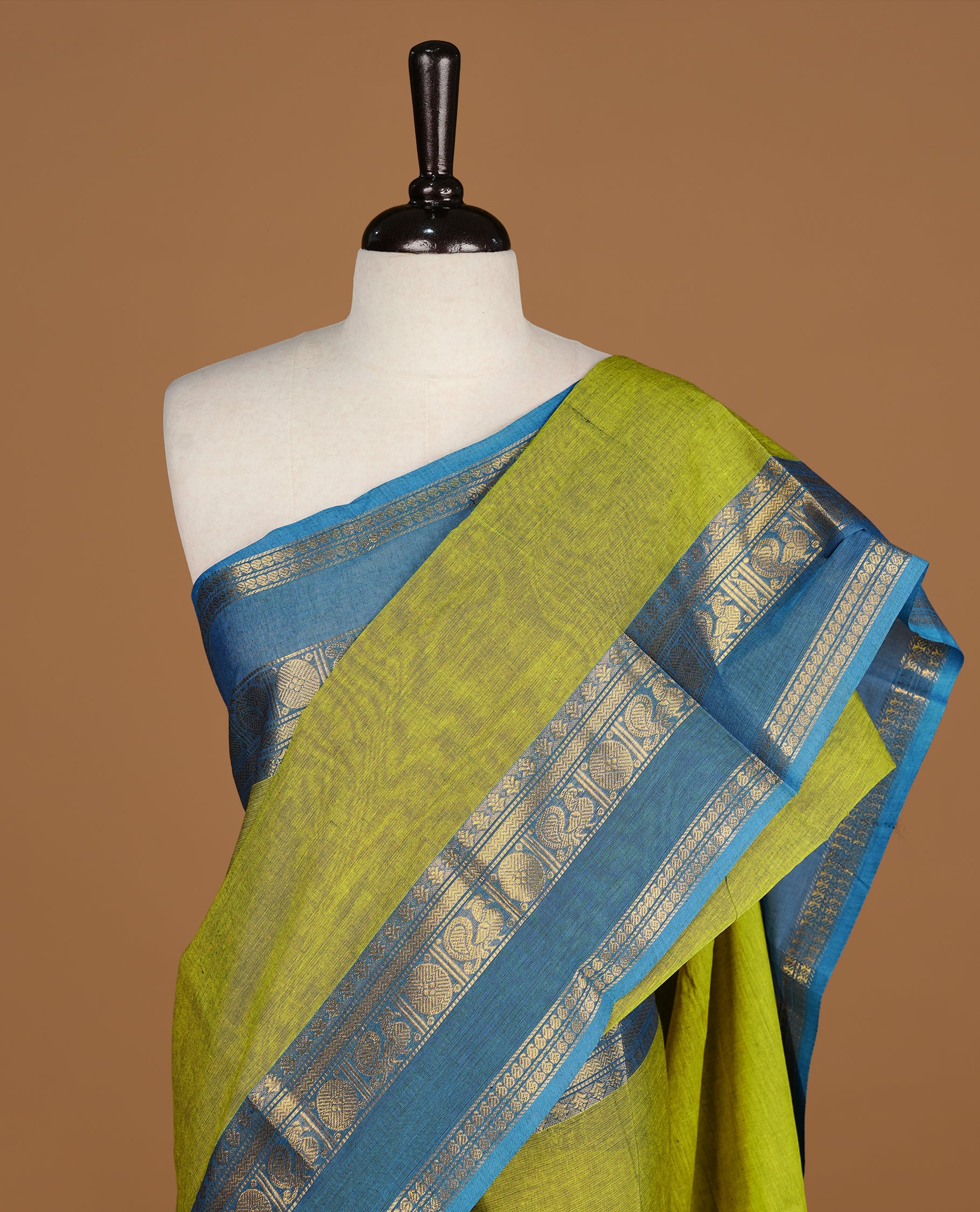 Lemon Green colour Chettinad cotton saree featuring Elegant plain body, complemented by contrast Blue colour with gold zari border, paired with matching blouse piece.