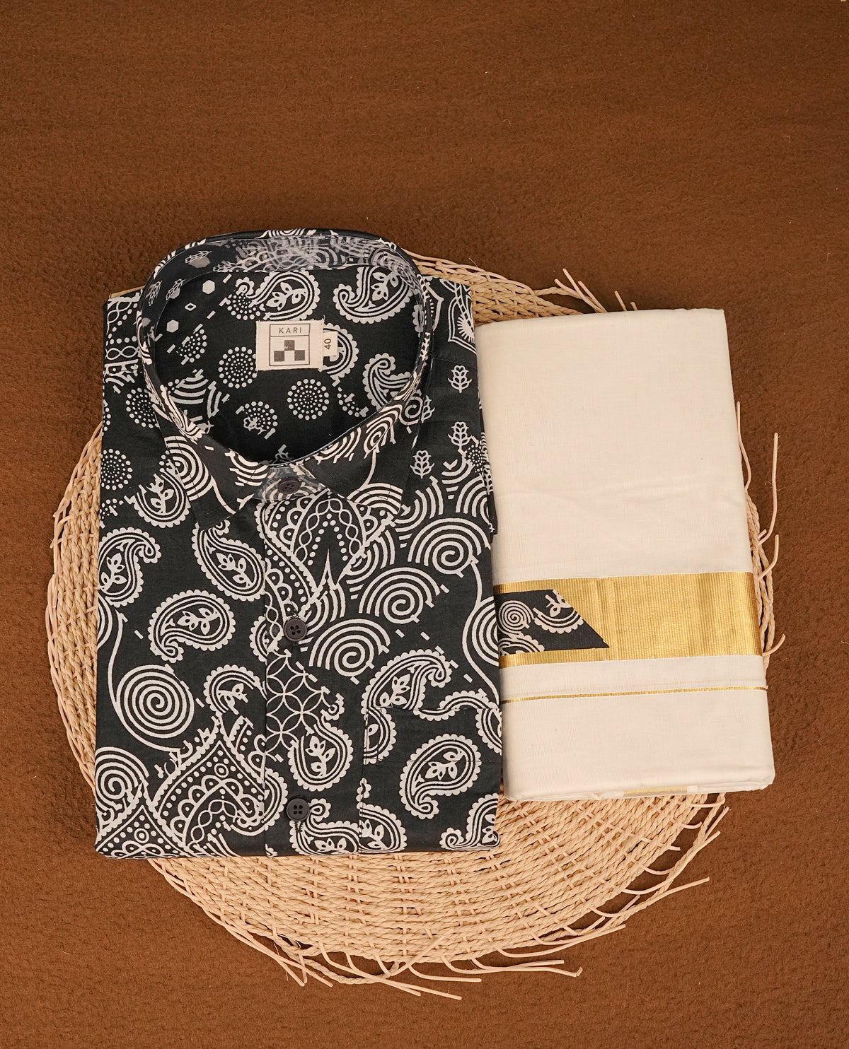 Black colour shirt featuring Floral Pattern printed body, paired with cream colour double dhoti featuring gold zari with same pattern printed border.