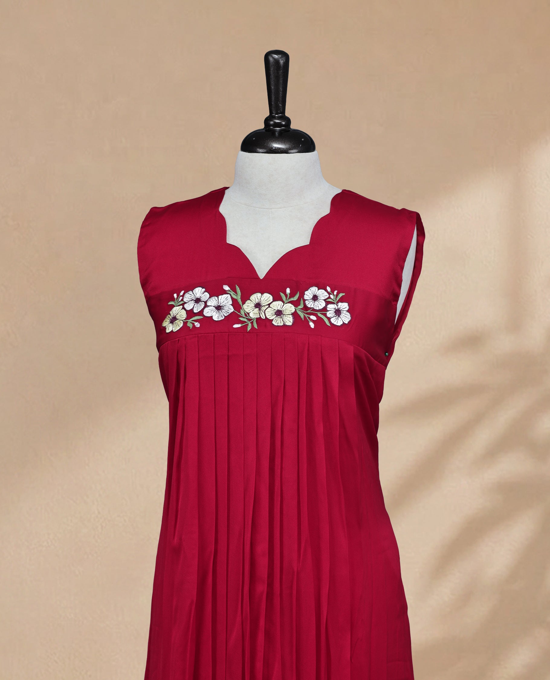 Red Coloured Sleeveless Kurti Featuring a Designed Neckline, Floral Embroidery on the Body
