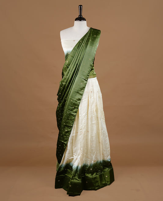 Off White colour half saree material featuring delicate zari buttas on the blouse and skirt, paired with a contrast Green zari border and matching small zari motifs dupatta