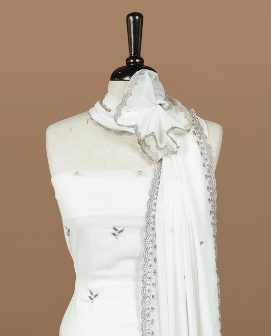White colour churidhar material featuring gold thread floral pattern on body, paired with matching bottom & dupatta.