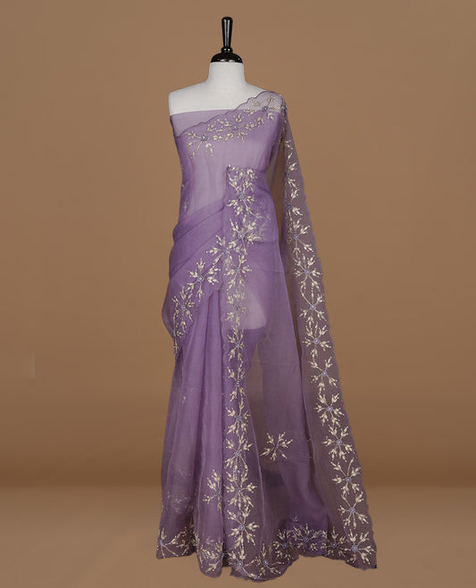 Pastel purple colour crush organza saree featuring gold thread floral and stone worked body, highlighting scalp designed border, paired with matching blouse piece.