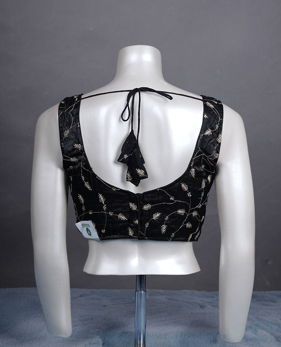 Black embroidered padded blouse with gold vine detailing, V neckline, and tie-back finish.