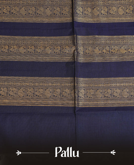Navy blue colour chettinad cotton saree featuring gold zari motifs on body, complemented by contrast green & magenta with gold zari border, comes with matching blouse piece.