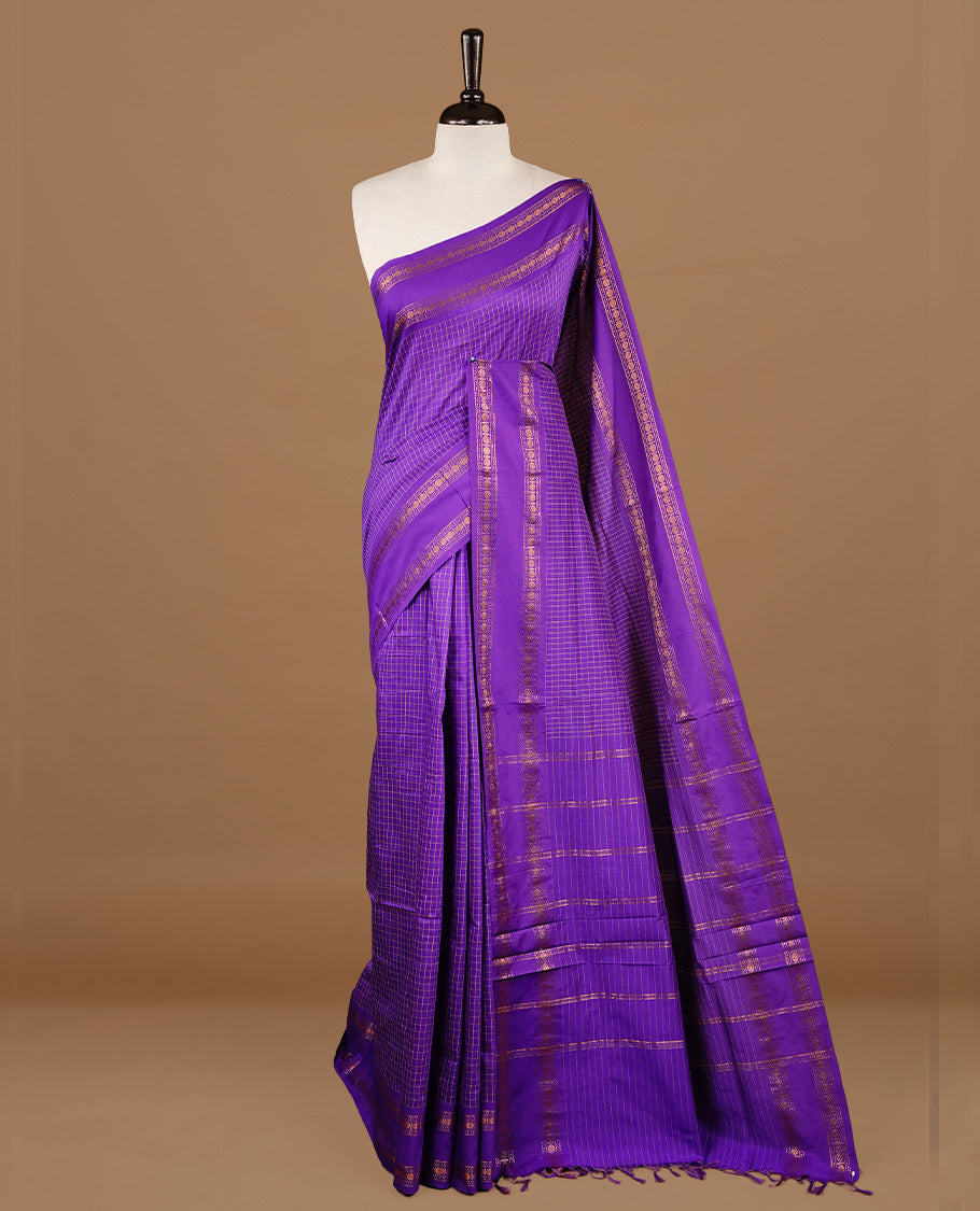 Indigo colour kalyani cotton saree featuring check pattern on body, highlighting self colour with simple gold zari border, paired with matching blouse piece.
