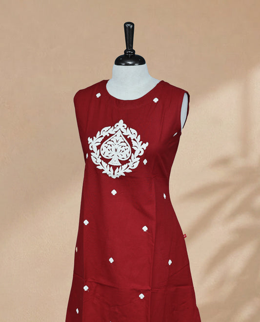 Rust Orange Kurti featuring threadwork across the body, a round neckline with threadwork on the yoke, and a sleeveless design.