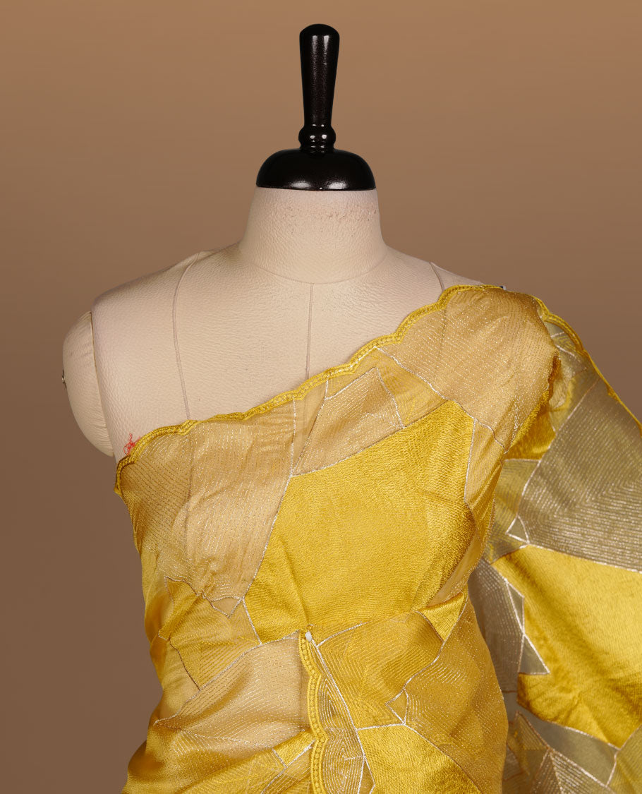 Yellow colour Organza designer saree featuring a thread geometric pattern across the body, enhanced with a piping border and cut beats work on matching blouse piece.