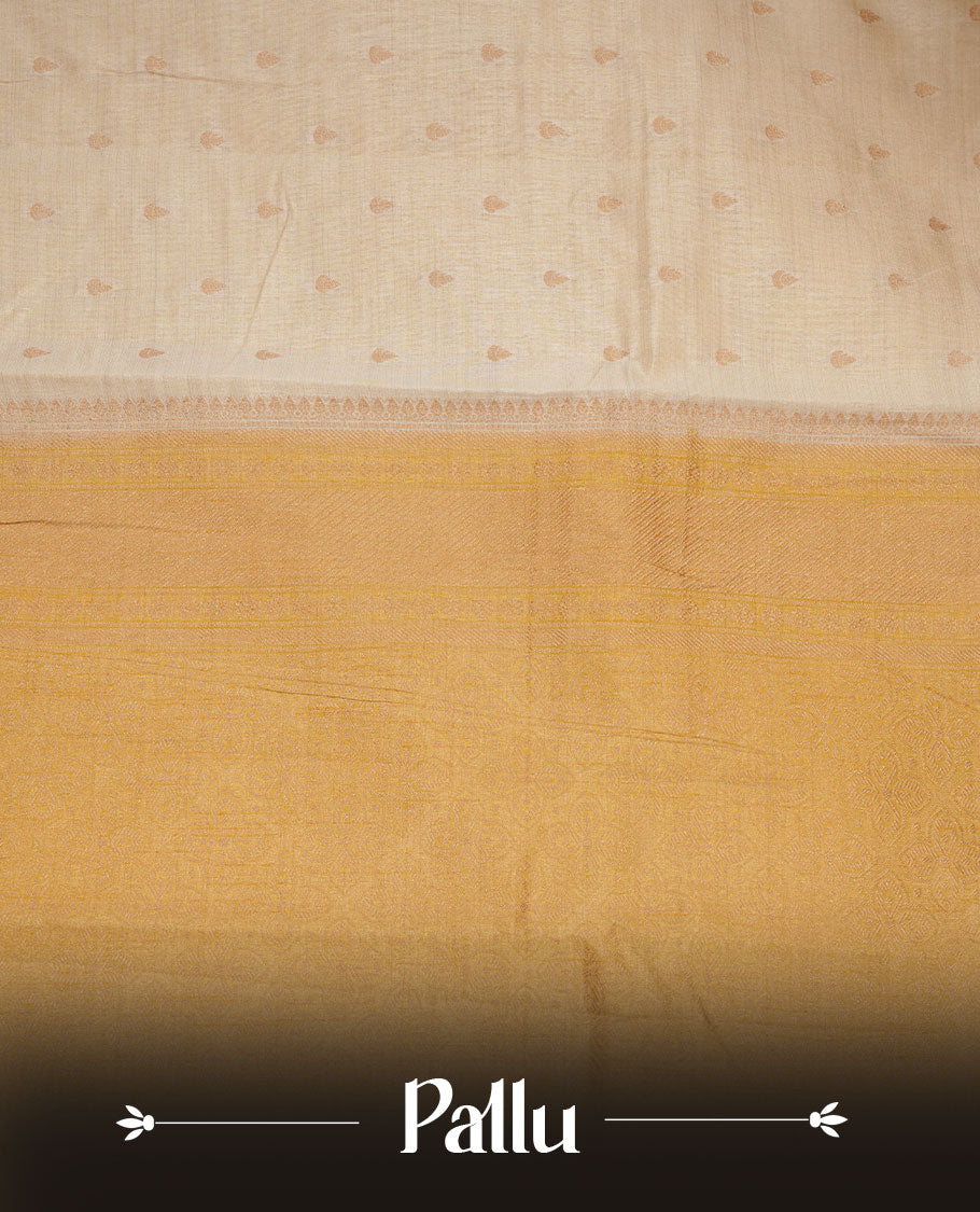White gold colour semi tussar saree featuring Gold zari buttas body, contrast Yellow colour gold zari border and comes with matching blouse piece.