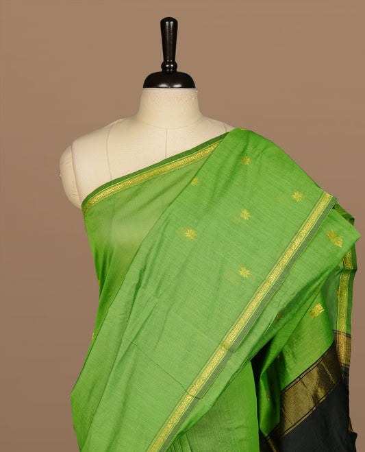 Green colour Maheshwari cotton saree features elegant gold zari motifs across the body, a classic gold zari border, a striking contrast pallu, and a matching blouse piece.