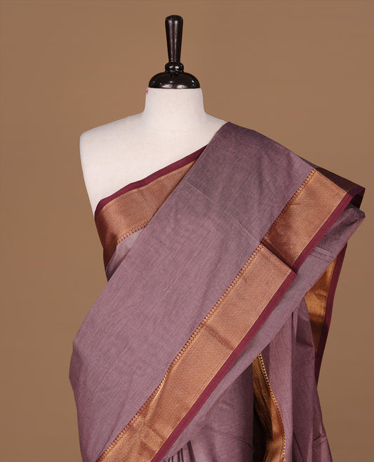 Bronze colour Chettinad Cotton saree featuring elegant plain body, complemented by contrast maroon colour with gold zari border, paired with matching blouse piece.