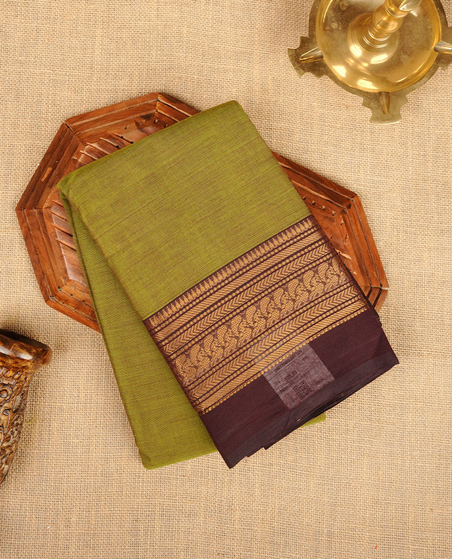 Olive green colour chettinad cotton saree featuring plain body, contrast Dark Brown colour with traditional gold zari border without blouse.