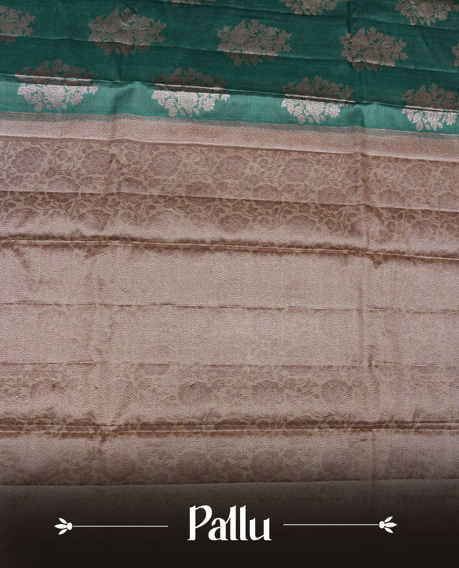 Green colour pure banaras tusser silk saree highlighting antique zari pattern across body, with contrast cream colour with zari border and paired with matching blouse