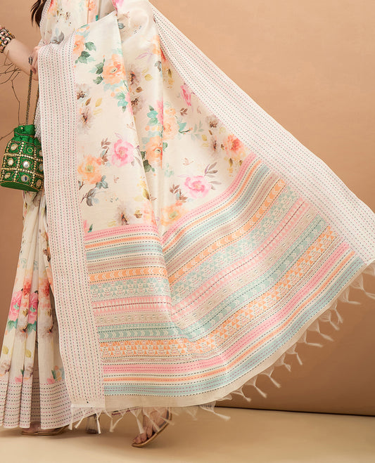Cream toned semi tussar saree featuring delicate multicolour floral prints on the body, accented with a pastel hued Katha style stitched border and printed pallu Comes with a matching floral printed blouse for a graceful look.