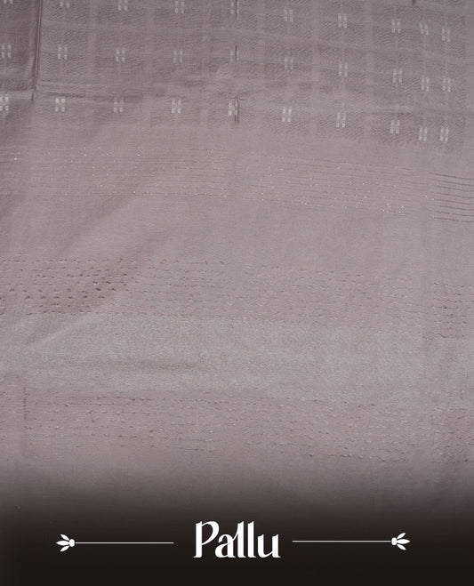 Gray colour semi jute saree highlighting white thread motifs on body, without border and paired with matching blouse.