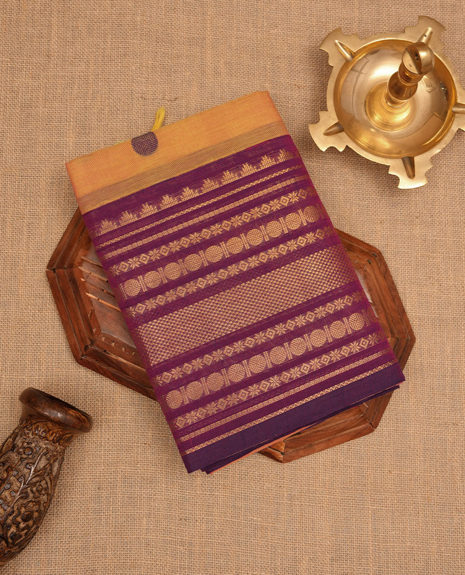 Dusty orange colour chettinad cotton saree featuring Purple colour motifs on body, contrast purple colour border with gold zari border, pallu and paired with matching blouse.
