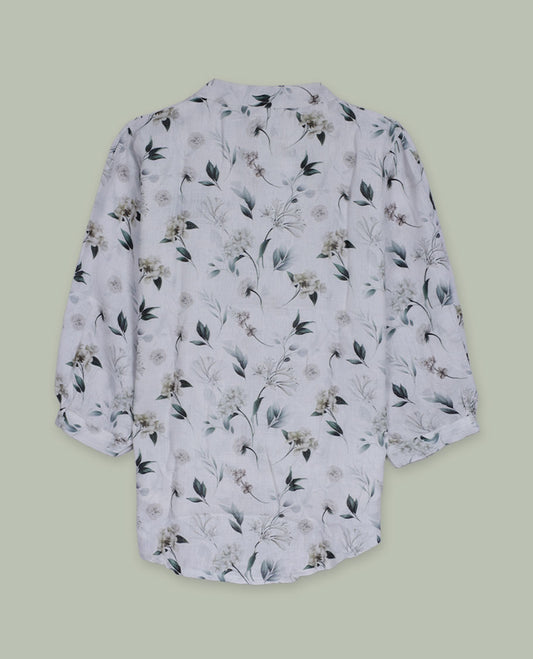 White floral printed shirt top with band collar, three-quarter sleeves, and front button placket framed by intricate lace and pintuck detailing.