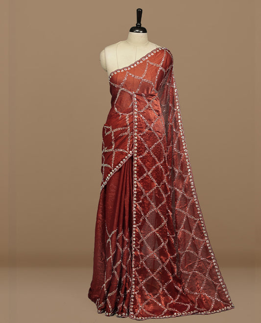 Brownish Orange colour designer saree featuring Sequins & cut beats worked body, cut beat worked border, paired with matching unstitched blouse.