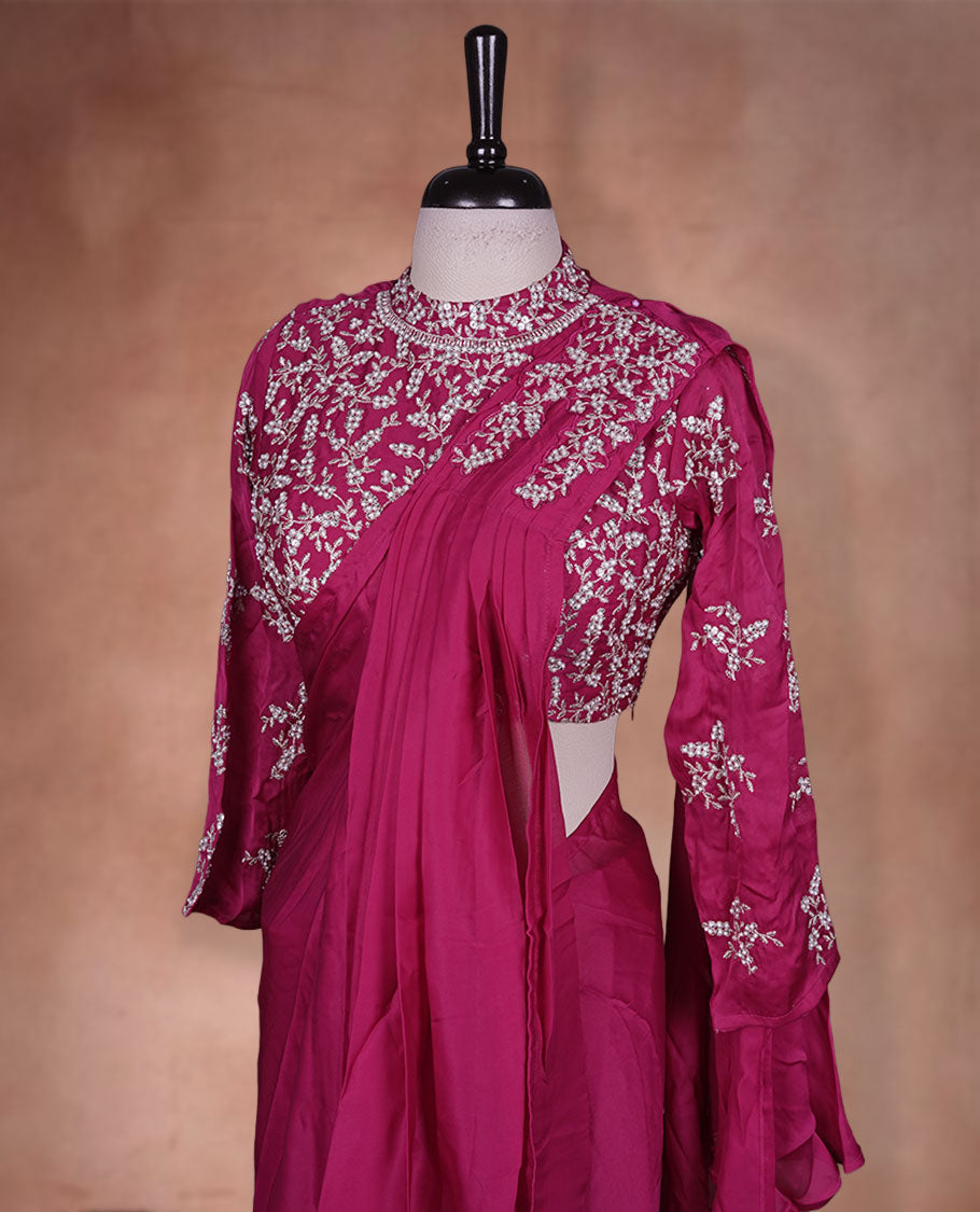 Rani pink colour ready to wear saree Fearturing intricate silver embroidery on the pallu, paired with a beats and thread embroidered matching blouse.