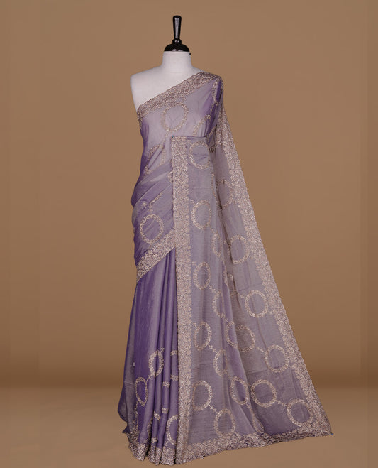 Lavender colour organza saree featuring thread & gold stone pattern on body, highlighting scalp border, paired with matching blouse piece.