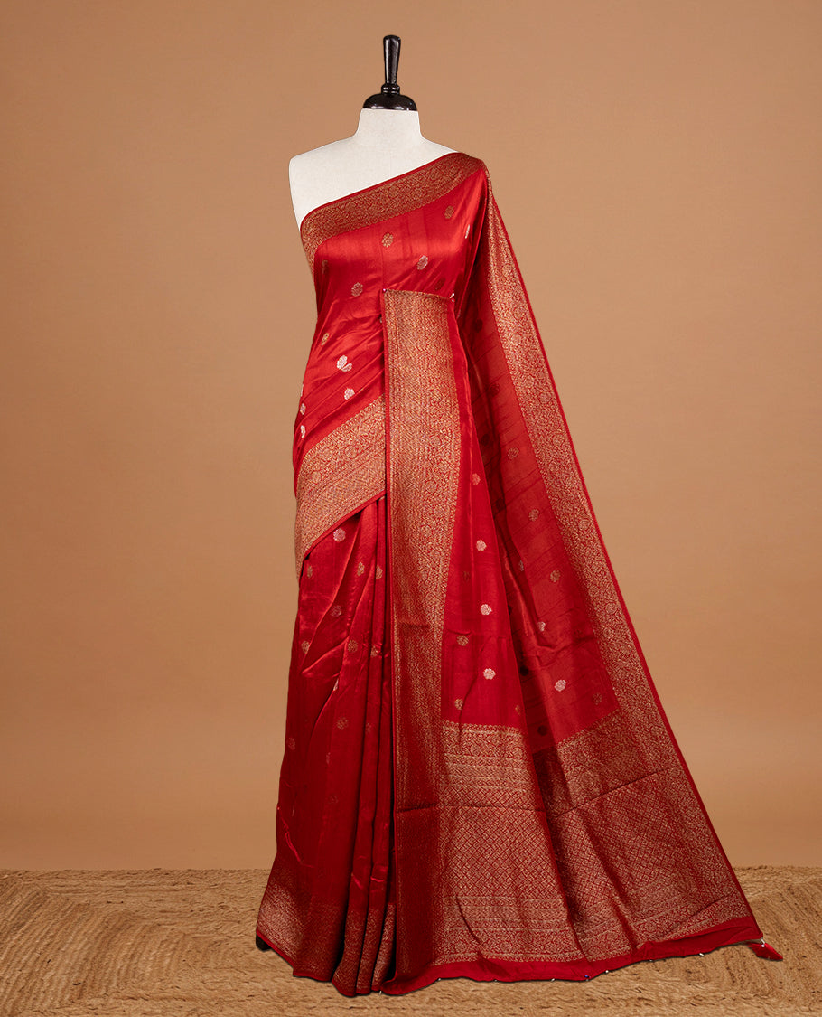 Red colour Semi banaras tussar georgette Saree featuring Antique zari motifs on body, enhanced with antique zari border, paired with a matching blouse piece.