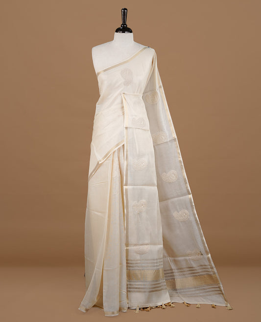 Cream colour Tussar saree featuring cream colour Mango pattern with chikankari embroidery work, highlighting gold zari simple border, paired with matching unstitched blouse.