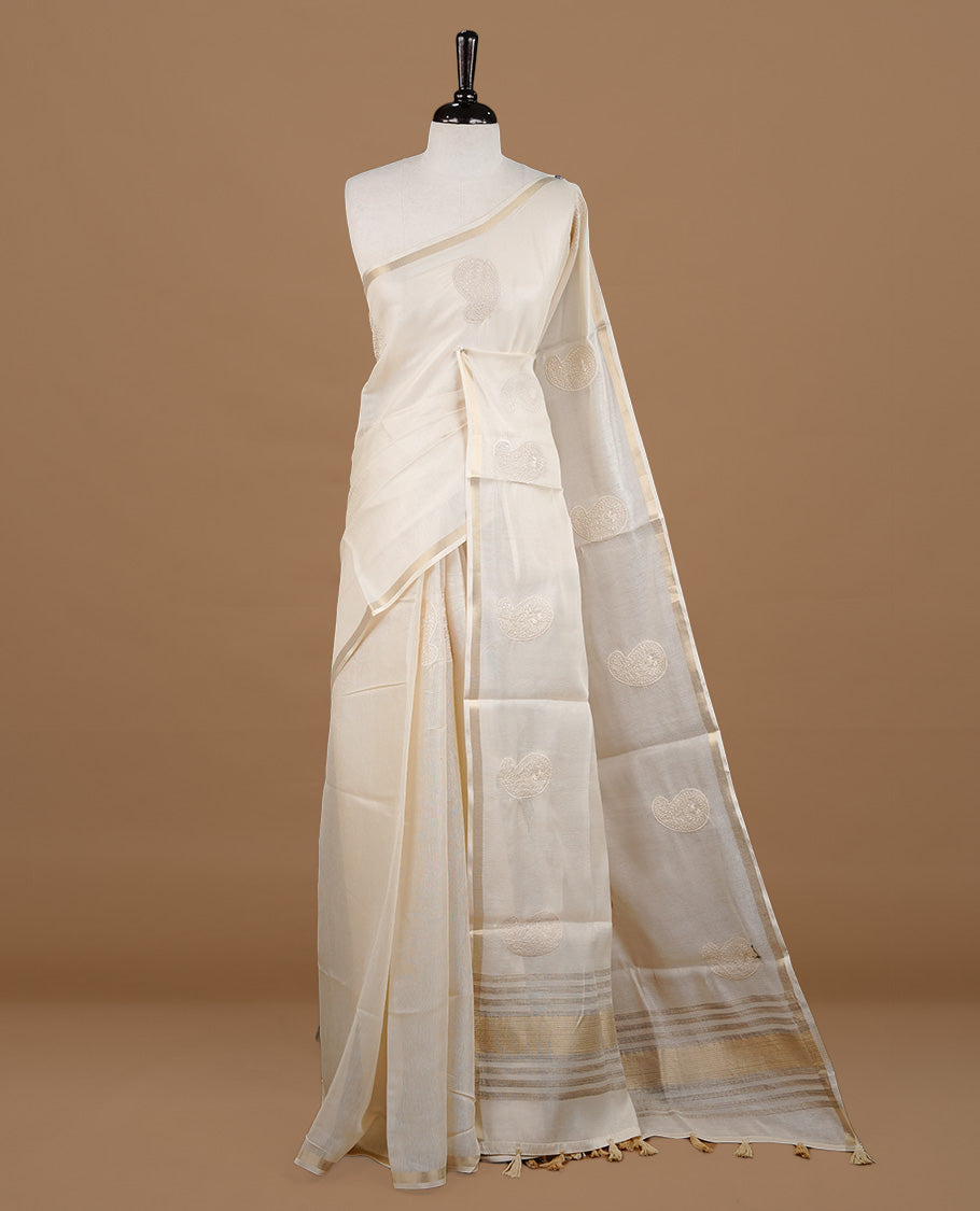 Cream colour Tussar saree featuring cream colour Mango pattern with chikankari embroidery work, highlighting gold zari simple border, paired with matching unstitched blouse.