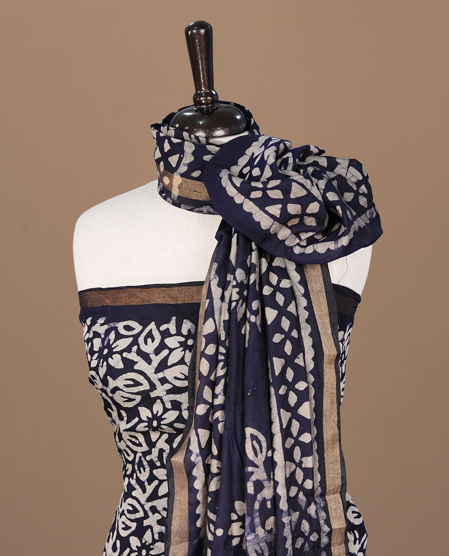 Dark blue colour churidhar material featuring cream colour floral kodi print on body, paired with matching bottom and Dupatta.