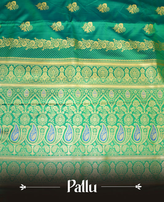 Green colour Banaras Satin Crepe saree featuring gold zari floral motifs on the body, a richly woven traditional border with intricate gold zari detailing, and paired with a matching blouse.