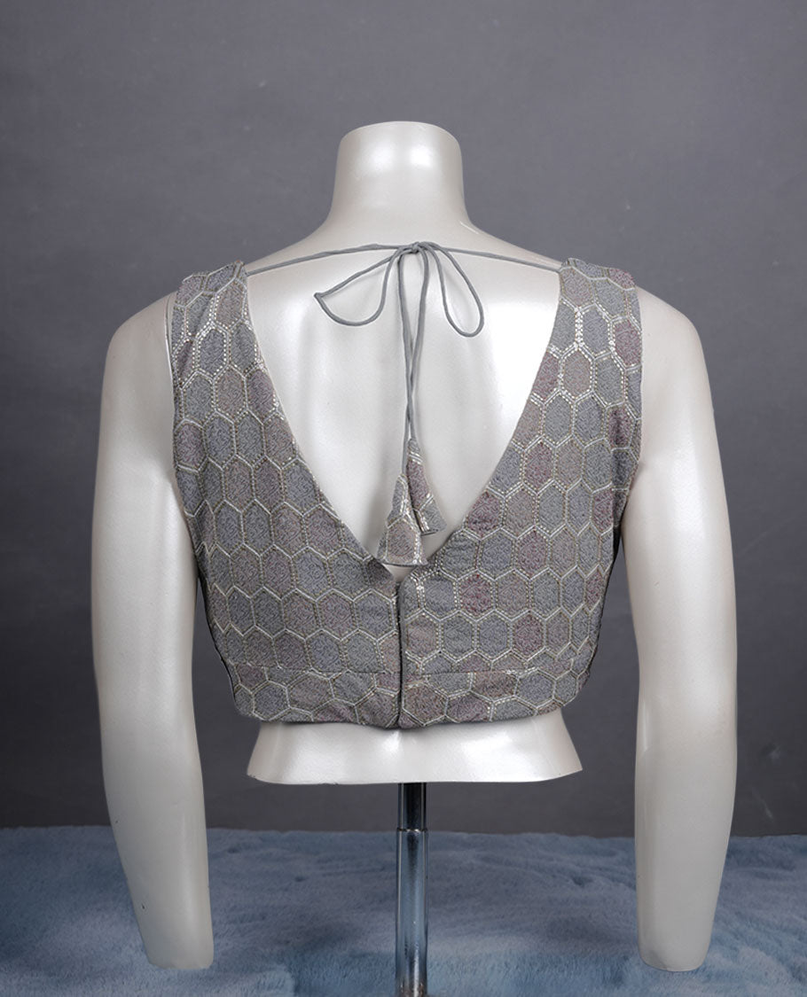 Grey colour padded blouse with gold hexagon weave, sleeveless V-neck, and deep V-back with tie-up tassels.