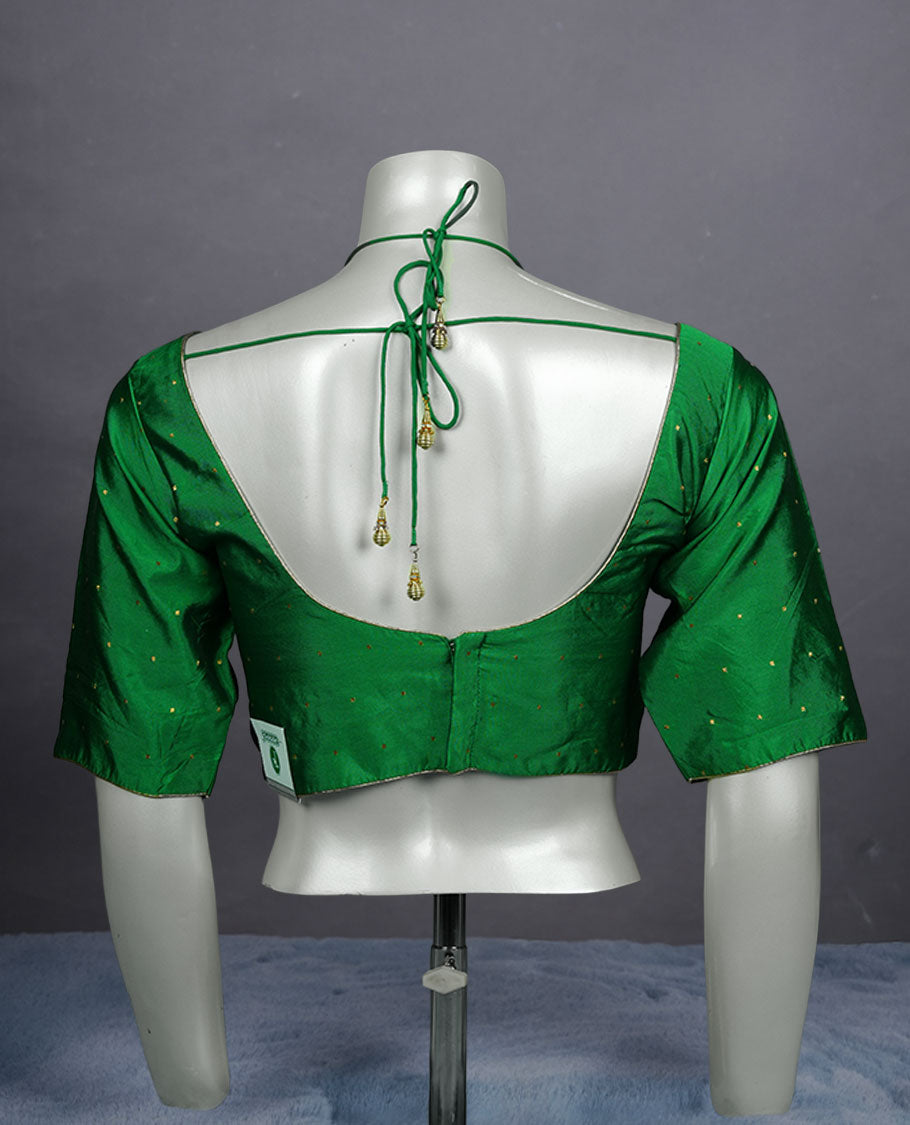 Bright green colour padded blouse with gold polka dots, V neckline, elbow sleeves, and deep tie-up back.