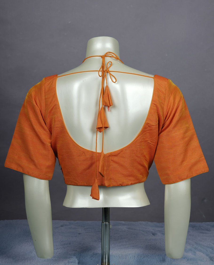 Orange colour silk padded readymade blouse with elbow-length sleeves, a V-neck front, and a deep U-back with tie-up dori.