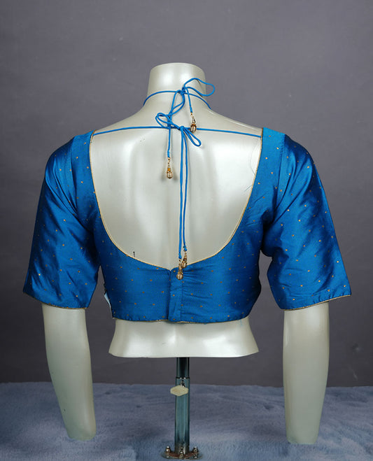Blue colour padded blouse with gold polka dots, V neckline, elbow sleeves, and deep tie-up back.