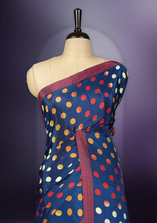 Blue colour saree with red, white & yellow motifs, diamond border, and bold pallu & Comes with a paired matching blouse.
