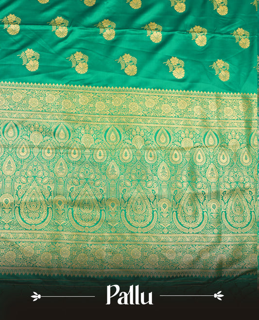 Green colour Banaras Satin Crepe saree featuring gold zari floral motifs on the body, a richly woven traditional border with intricate gold zari detailing, and paired with a matching blouse.