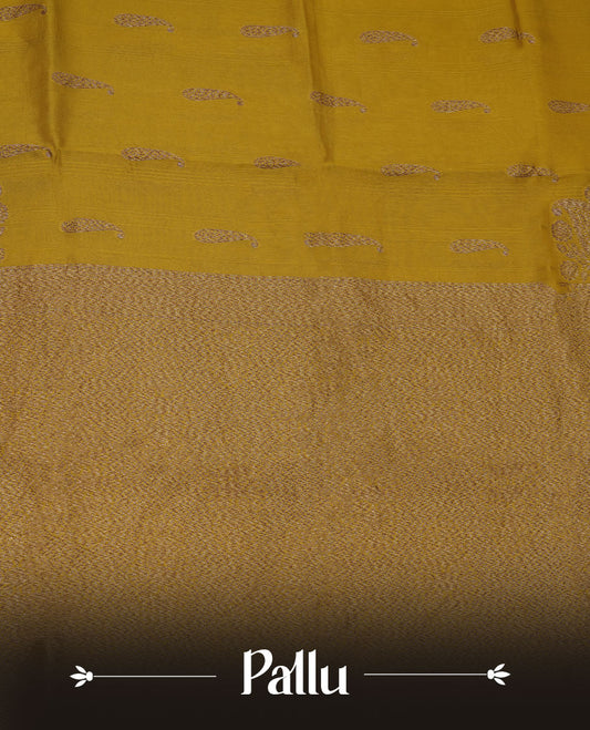 Yellow colour semi banaras tussar georgette featuring gold zari leaf pattern across body, finished with gold zari border and paired with matching blouse.