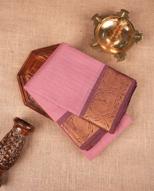 Light pink colour sungudi cotton saree featuring gold zari check pattern across body, contrast Mauve colour with gold zari peacock and floral pattern on border, without blouse piece.