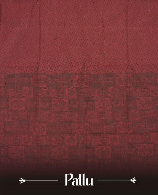 Deep Maroon colour poly cotton saree with black zigzag line pattern on the body, paired with a matching pallu featuring black chevron lines and panelled floral‑paisley design, and a coordinated all‑over floral paisley patch‑style printed blouse piece.