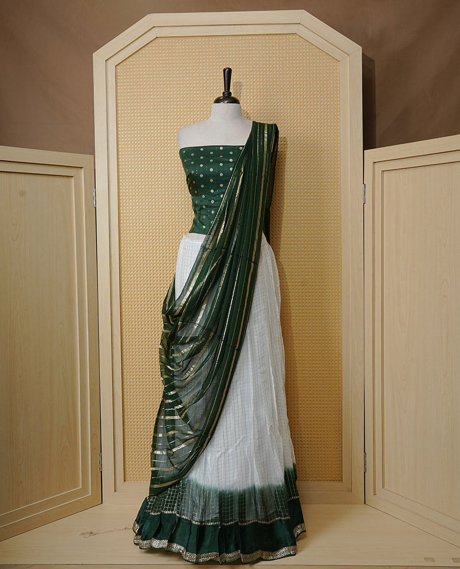 Off white colour Semi stitched dhavani set featuring Gold zari check pattern with contrast Bottle green border skirt, paired with matching blouse & dupatta.