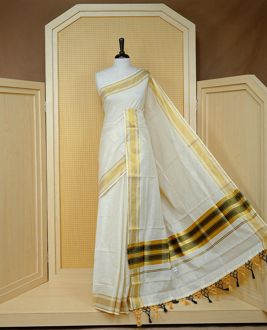 Cream colour Cotton kerala saree featuring Gold zari Checks on body, complemented by Gold zari border & Black with gold zari on Pallu, paired with matching blouse piece.