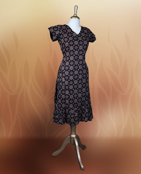 Black colour nightwear adorned with soft maroon floral prints, featuring a V neckline, short sleeves, and a flared ruffle hem, A stylish and comfortable choice for daily wear, brunches, or casual outings.