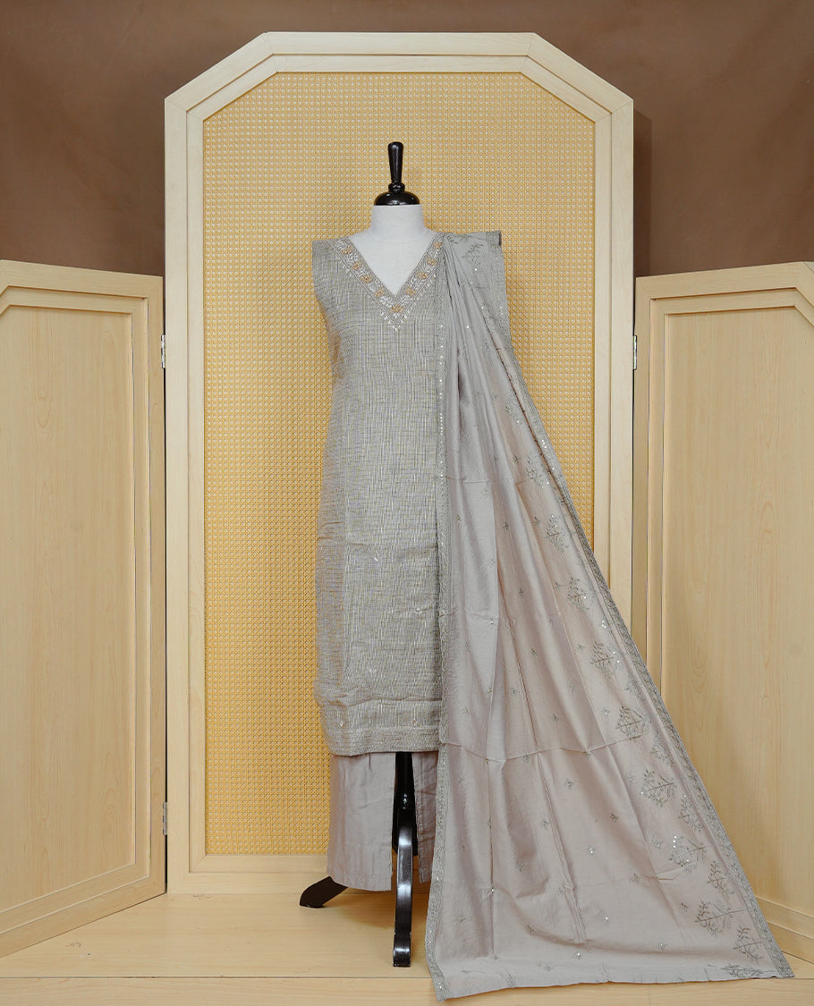 Tan Beige colour Tissue Churidar Set featuring delicate embroidery and subtle bead detailing on the yoke, paired with matching solid pants and dupatta.
