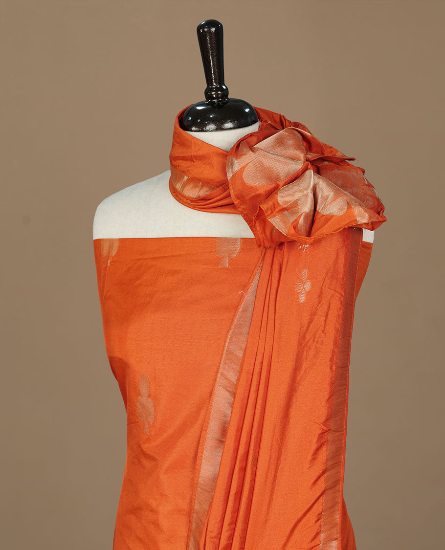 Orange colour churidhar material featuring gold zari card motifs on body, paired with matching bottom and Dupatta.