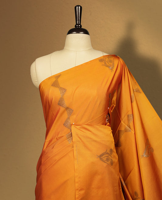 Mustard yellow colour semi soft silk saree, adorned with subtle woven motifs on the body & The design is elevated with an elegant zari border and pallu, paired with a matching blouse.