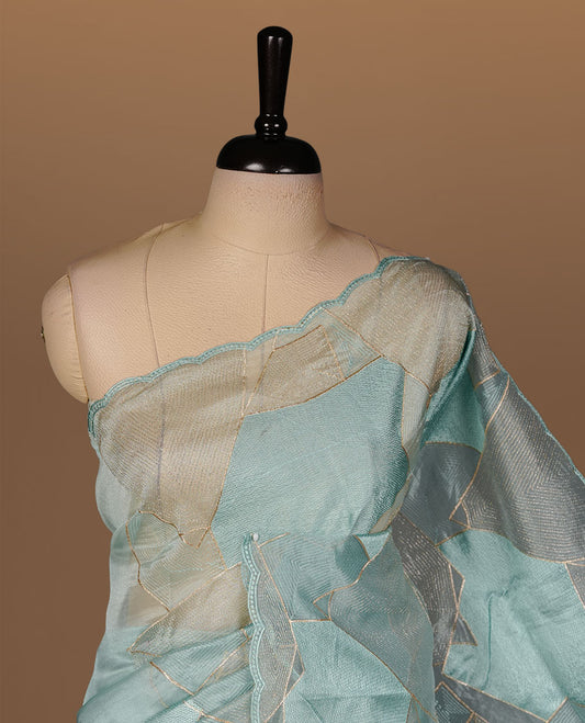 Mint blue colour Organza designer saree featuring a thread geometric pattern across the body, enhanced with a piping border and cut beats work on matching blouse piece.