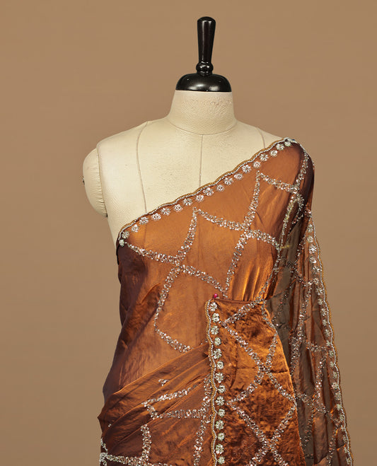 Golden Brown colour designer saree featuring Sequins & cut beats worked body, cut beat worked border, paired with matching unstitched blouse.